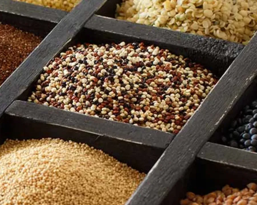 A wooden tray of assorted grains